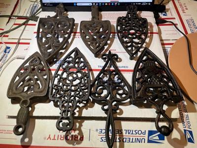 Vintage Lot of 7 Cast Iron Trivets - Varying Shapes, Sizes & Patterns as Pictured.