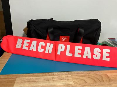 Pink cooler and Stoli duffle bag