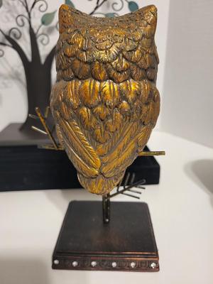 OWL PERCHED BY A TREE