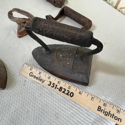 Antique sad irons & pieces