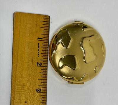 Gold tone metal mirror compact