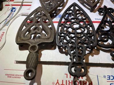 Vintage Lot of 7 Cast Iron Trivets - Varying Shapes, Sizes & Patterns as Pictured.