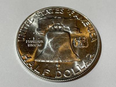1957 BRILLIANT UNCIRCULATED CONDITION FRANKLIN SILVER HALF DOLLAR AS PICTURED.