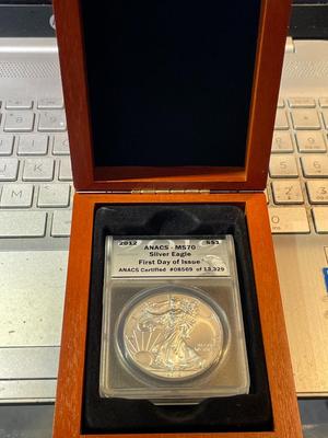 ANACS CERTIFIED 2012 MS70 FIRST DAY OF ISSUE AMERICAN SILVER EAGLE IN A CUSTOM WOODEN BOX.