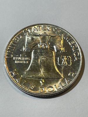 1957-D BU FULL BELL LINES CONDITION LIGHTLY TONED FRANKLIN SILVER HALF DOLLAR.