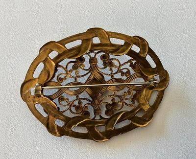 Victorian Brass openwork brooch with color center stone