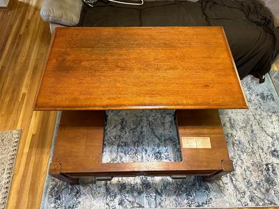 LIFT COFFEE TABLE WITH SOME LOSS OF FINISH TO THE TOP