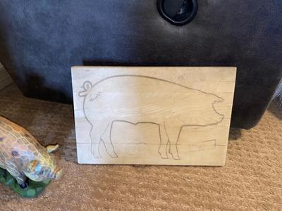 ARNOLD THE HAWG ON A CO-OP CUTTING BOARD AND BABY HAM HITCHING A RIDE ON MAMA PIG