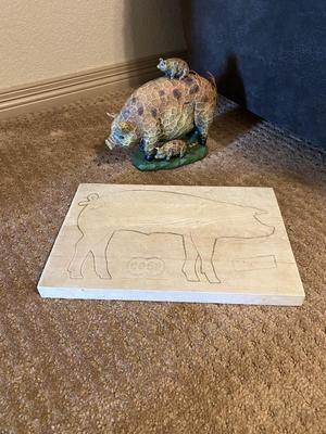 ARNOLD THE HAWG ON A CO-OP CUTTING BOARD AND BABY HAM HITCHING A RIDE ON MAMA PIG