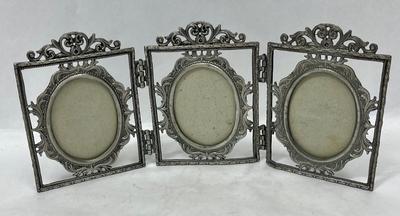 Hinged metal picture frame for oval shaped photos