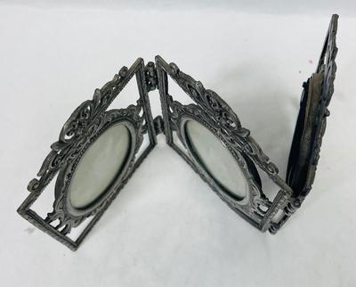 Hinged metal picture frame for oval shaped photos