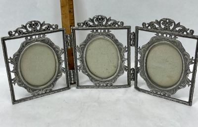 Hinged metal picture frame for oval shaped photos