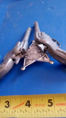 LOT 84 - TWO OLD CAP GUNS AND TOY BADGE