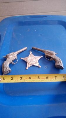 LOT 84 - TWO OLD CAP GUNS AND TOY BADGE