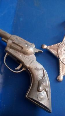 LOT 84 - TWO OLD CAP GUNS AND TOY BADGE