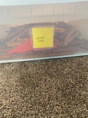 A CONTAINER OF LINCOLN LOGS