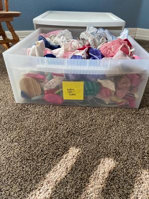 CHILD SIZE ROCKING CHAIR AND TOTE FULL OF DOLL CLOTHES