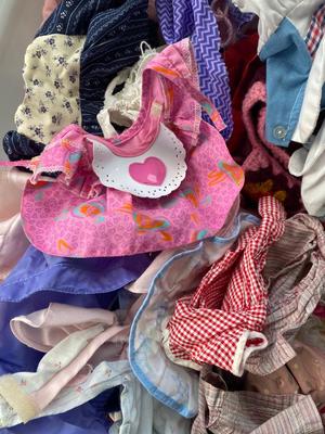 CHILD SIZE ROCKING CHAIR AND TOTE FULL OF DOLL CLOTHES