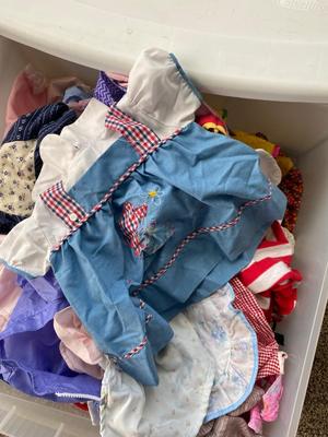 CHILD SIZE ROCKING CHAIR AND TOTE FULL OF DOLL CLOTHES