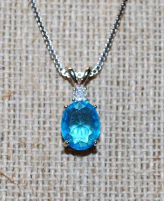 Oval Cut Sea Blue Stone with a Clear Stone on Top PENDANT (½" x ¼") and Double Hooks on a Silver Tone Necklace Chain 17" L