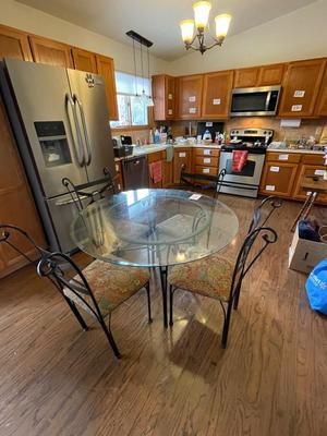 BEVELED GLASS TABLE WITH FOUR IRON CHAIRS