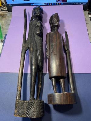 2 Vintage Ebony Hand Carved African Wood Statue Figurines w/Spears 12" & 15" in Good Preowned Condition as Pictured.