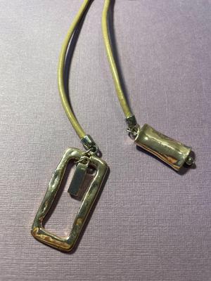 Modern Day Bolo Tie Gold-tone Necklace on a Beige/Creme Color Cord in VG Preowned Condition.
