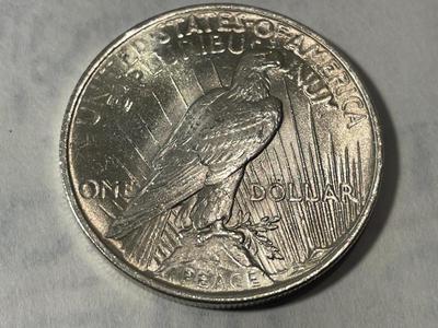 1923-P MS60/UNC. SCRATCHED OBVERSE (UNCERTIFIED) PEACE SILVER DOLLAR AS PICTURED.