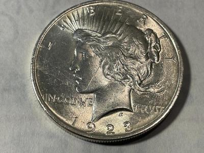 1923-P MS60/UNC. SCRATCHED OBVERSE (UNCERTIFIED) PEACE SILVER DOLLAR AS PICTURED.