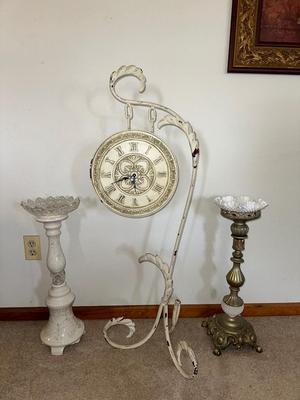 HANGING CLOCK ON AN IRON FRAME AND 2 FLOOR PILLAR CANDLE HOLDERS