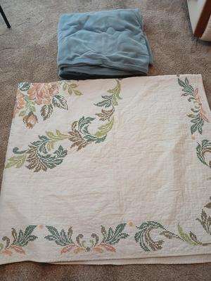 Embroidered floral quilt with soft blue blanket