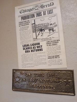 Brass Plaque that reads "On this site in 1897 nothing happened with a Chicago Herald Prohibition ends faux paper