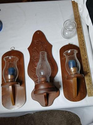 Three wooden wall hanging candle sconces with glass globes