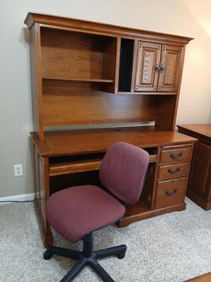 Golden Oak Desk with top hutch with two drawer keys and an office chair