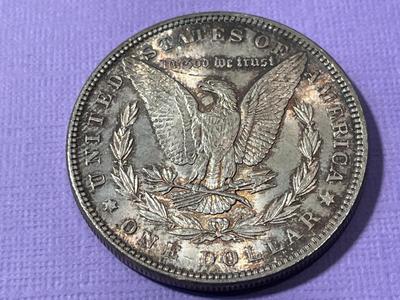 1885-P UNCIRCULATED/TONED MORGAN SILVER DOLLAR AS PICTURED.
