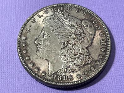 1885-P UNCIRCULATED/TONED MORGAN SILVER DOLLAR AS PICTURED.
