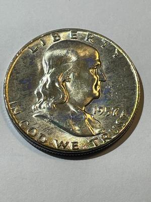 1957-D BU FULL BELL LINES CONDITION LIGHTLY TONED FRANKLIN SILVER HALF DOLLAR.