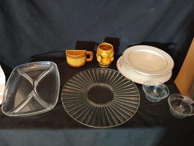 A half cup of coffee mug, divided glass tray, large bowl with plate, glass platter and more