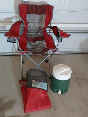 Mesh folding camp chair with carry bag and a green igloo drink cooler