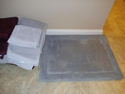 Grey and maroon towels with a better homes & garden memory foam bathmat