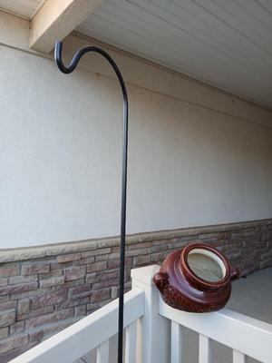 Pottery pot for plants, and a shepherd hook