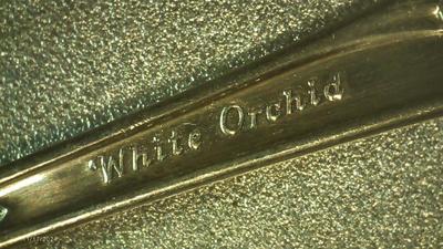 Community silver plate. "White Orchid" baby spoon.