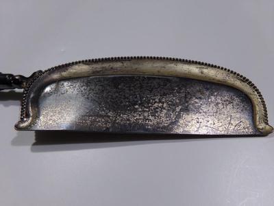 A serving device, maybe for cheese?