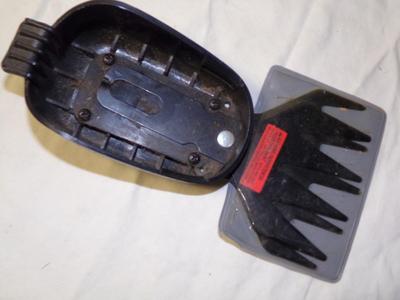 Black&Decker gizmo with cutter blades and a hanger bracket.