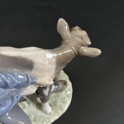 LOT 102: Royal Copenhagen Figurine #772: Boy with Stubborn Calf