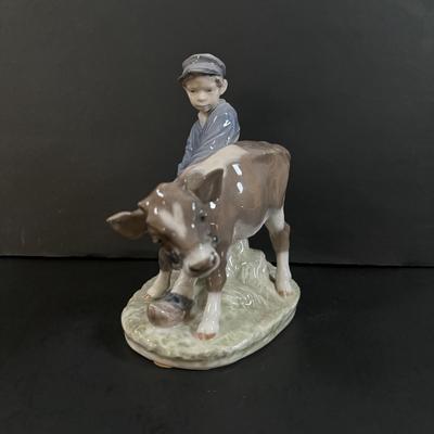 LOT 102: Royal Copenhagen Figurine #772: Boy with Stubborn Calf