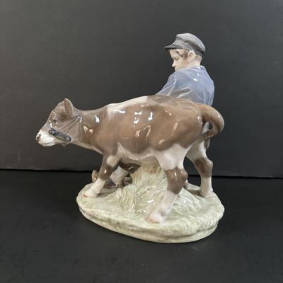 LOT 102: Royal Copenhagen Figurine #772: Boy with Stubborn Calf