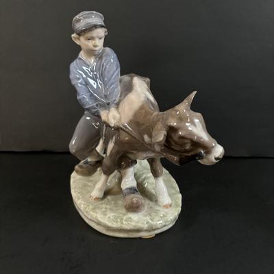 LOT 102: Royal Copenhagen Figurine #772: Boy with Stubborn Calf
