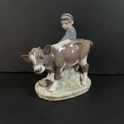 LOT 102: Royal Copenhagen Figurine #772: Boy with Stubborn Calf