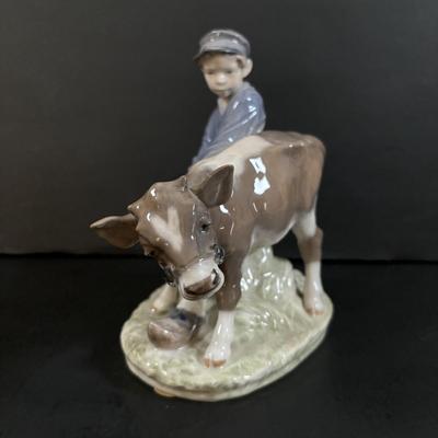 LOT 102: Royal Copenhagen Figurine #772: Boy with Stubborn Calf